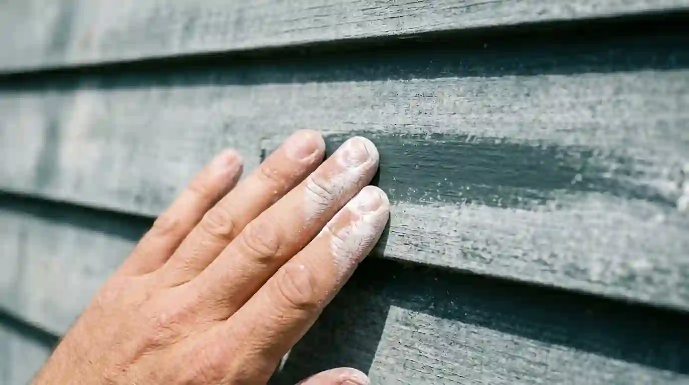 Chalk residue on a hand from aging exterior paint